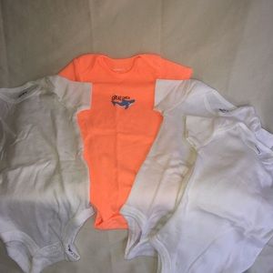 4 Carter’s onesies. 3 White. I orange.
